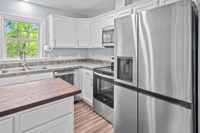 419 Hidden Hill Rd, Tryon, NC 28782 - kitchen with appliances with stainless steel finishes, butcher block counters, white cabinetry, and light wood-type flooring
