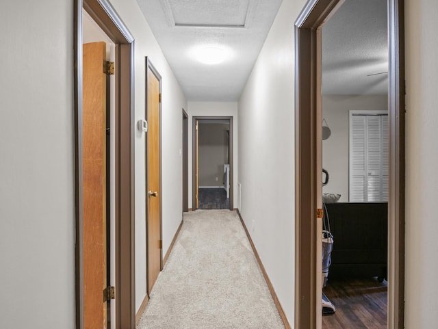 228 Anita Dr, Spartanburg, SC 29302 - hallway featuring a textured ceiling, carpet floors, and attic access