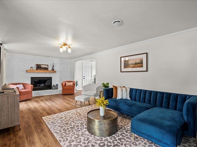 207 Bartlett St, Mauldin, SC 29662 - living area featuring wood finished floors, ornamental molding, and a brick fireplace