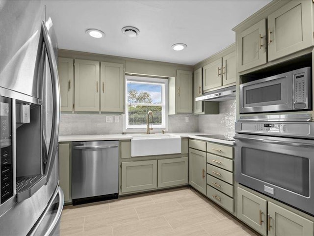 207 Bartlett St, Mauldin, SC 29662 - kitchen featuring appliances with stainless steel finishes, under cabinet range hood, backsplash, light countertops, and recessed lighting