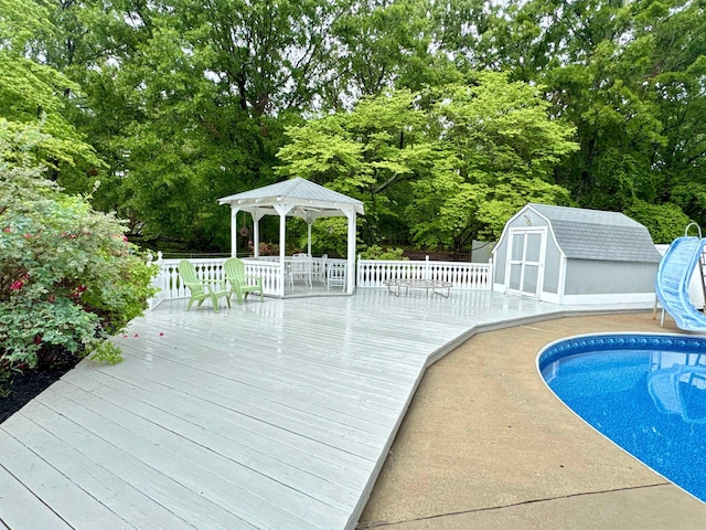 8627 Valley Falls Rd, Boiling Springs, SC 29316 - swimming pool featuring a gazebo, a water slide, a deck, and a storage unit