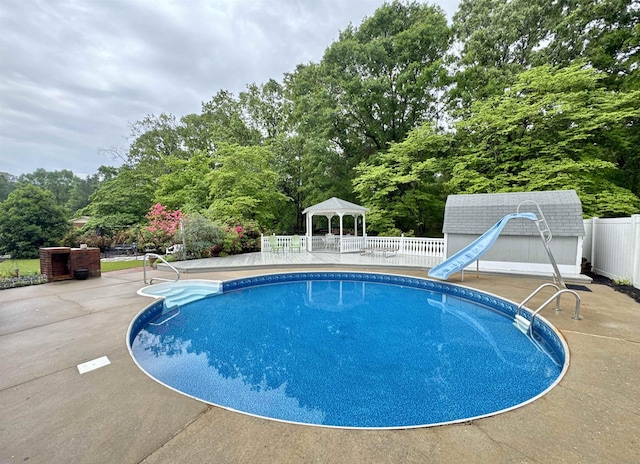 8627 Valley Falls Rd, Boiling Springs, SC 29316 - view of pool featuring a gazebo, a water slide, view of wooded area, and a patio area