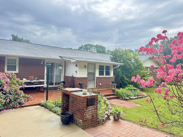 8627 Valley Falls Rd, Boiling Springs, SC 29316 - view of front of home with brick siding, a porch, a shingled roof, and a chimney