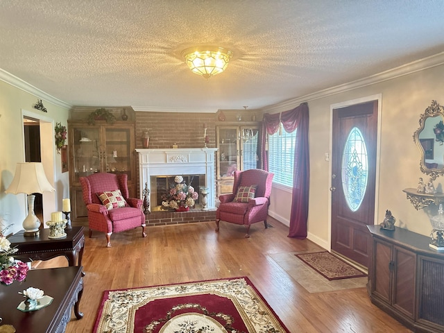 8627 Valley Falls Rd, Boiling Springs, SC 29316 - foyer featuring a textured ceiling, ornamental molding, wood finished floors, and a glass covered fireplace