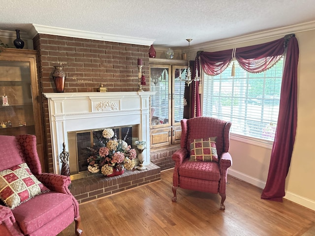 8627 Valley Falls Rd, Boiling Springs, SC 29316 - sitting room featuring ornamental molding, a textured ceiling, wood finished floors, and a fireplace