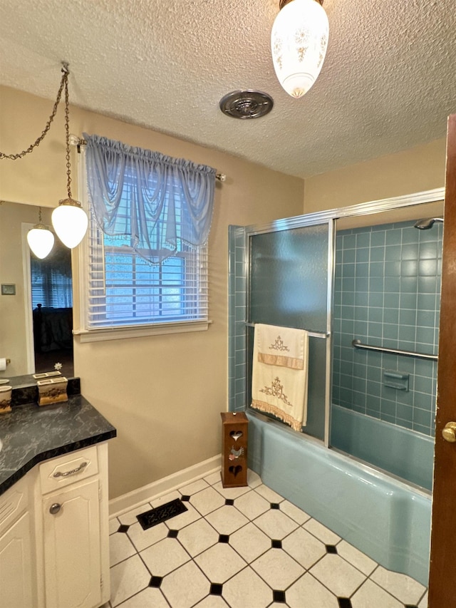 8627 Valley Falls Rd, Boiling Springs, SC 29316 - bathroom featuring vanity, a textured ceiling, and combined bath / shower with glass door