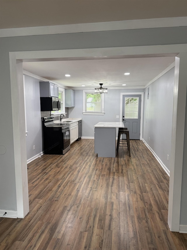 7 Pine Ln, Inman, SC 29349 - kitchen with appliances with stainless steel finishes, dark wood-style flooring, light countertops, recessed lighting, and a kitchen island