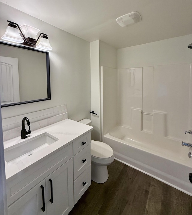306 Manning St, Spartanburg, SC 29304 - bathroom featuring wood finished floors, vanity, tasteful backsplash, and shower / tub combination