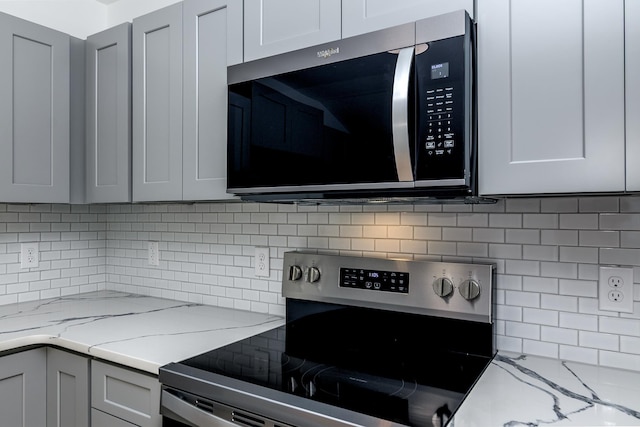 583 Berry Rd, Boiling Springs, SC 29316 - kitchen with appliances with stainless steel finishes, light stone counters, decorative backsplash, and gray cabinetry