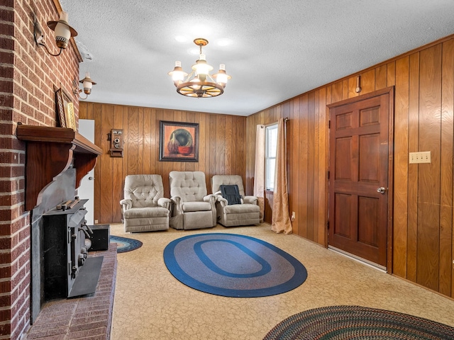 1310 Mount Zion Rd, Spartanburg, SC 29303 - living room with carpet, a chandelier, a wood stove, wooden walls, and a textured ceiling