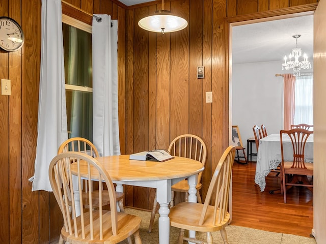 1310 Mount Zion Rd, Spartanburg, SC 29303 - dining space with wood walls, a chandelier, and wood finished floors
