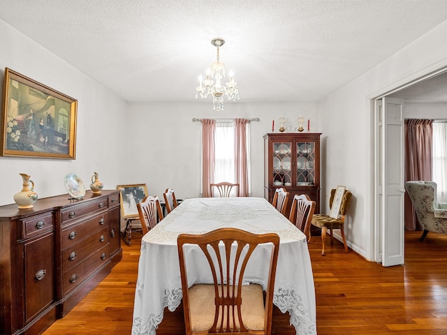 1310 Mount Zion Rd, Spartanburg, SC 29303 - dining room featuring a chandelier, light wood-type flooring, and a textured ceiling