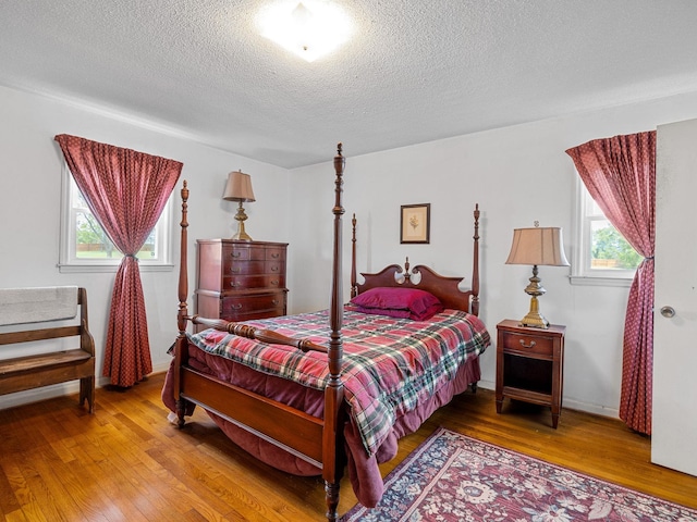 1310 Mount Zion Rd, Spartanburg, SC 29303 - bedroom with wood finished floors, multiple windows, and a textured ceiling