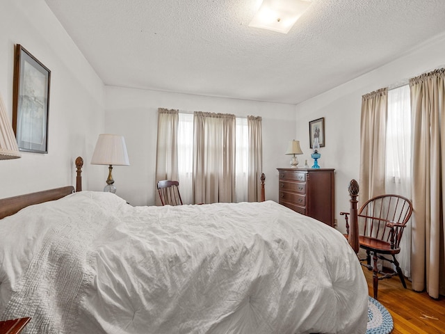 1310 Mount Zion Rd, Spartanburg, SC 29303 - bedroom featuring multiple windows, wood finished floors, and a textured ceiling