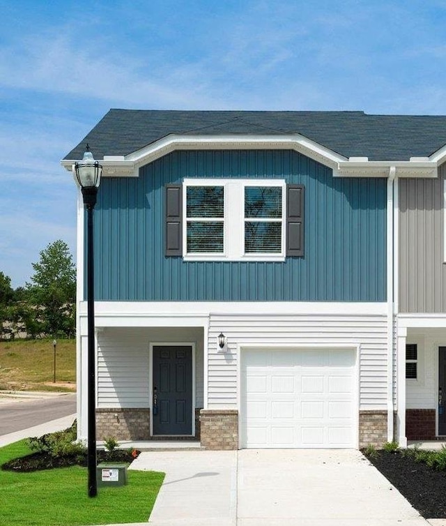 126 Arrow Ct, Greer, SC 29651 - view of front of property featuring board and batten siding, a garage, driveway, and brick siding