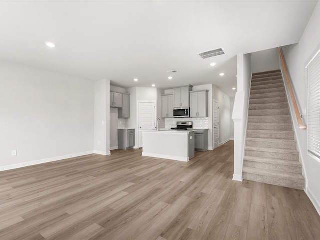 126 Arrow Ct, Greer, SC 29651 - unfurnished living room with light wood-style floors, stairs, and recessed lighting