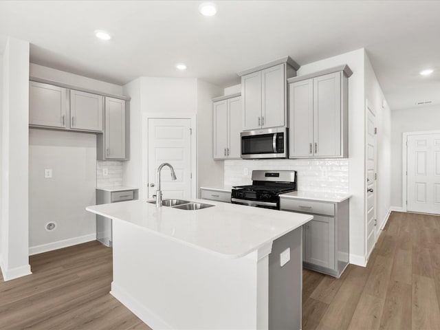 126 Arrow Ct, Greer, SC 29651 - kitchen with stainless steel appliances, gray cabinetry, decorative backsplash, and recessed lighting