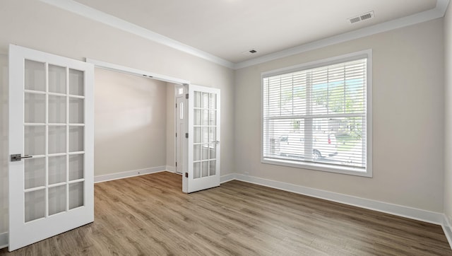 310 Fiery Rd, Mauldin, SC 29607 - unfurnished room with crown molding, wood finished floors, healthy amount of natural light, and french doors