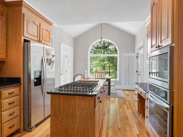 154 Broken Bow Run, Pickens, SC 29671 - kitchen featuring stainless steel appliances, light wood-style flooring, vaulted ceiling, and dark countertops