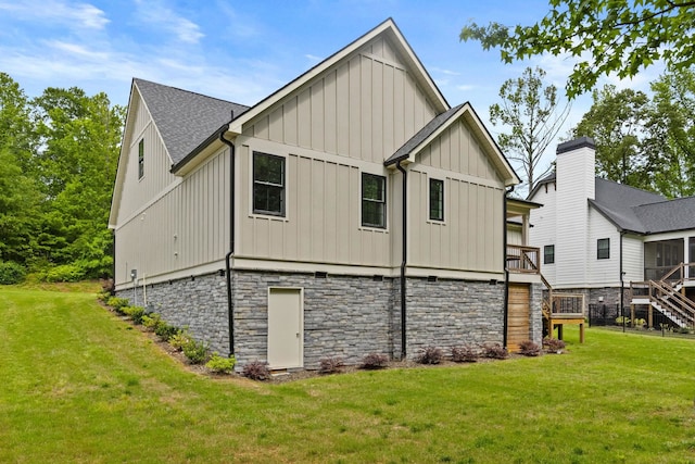 2032 Ivy Cottage Path, Boiling Springs, SC 29316 - rear view of house with board and batten siding, a lawn, and stone siding