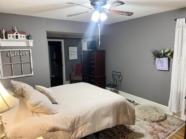 510 E Earle St, Landrum, SC 29356 - bedroom with wood finished floors, ceiling fan, and a textured ceiling