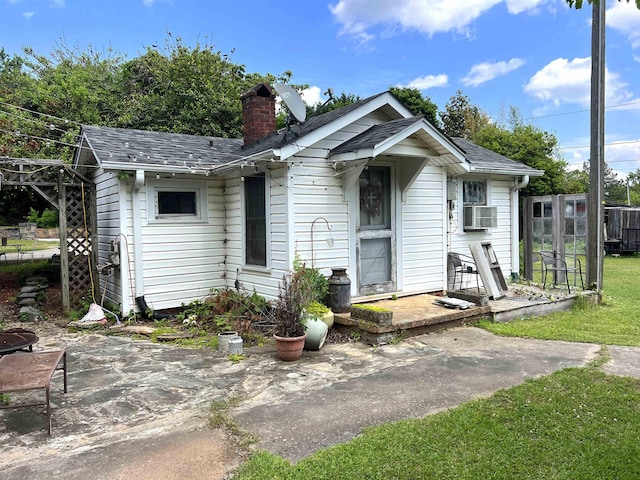 510 E Earle St, Landrum, SC 29356 - view of front facade with a chimney, a patio, cooling unit, and a shingled roof