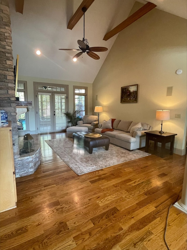 204 Tuscan Ridge Trl, Inman, SC 29349 - living room with high vaulted ceiling, beamed ceiling, ceiling fan, wood finished floors, and a stone fireplace
