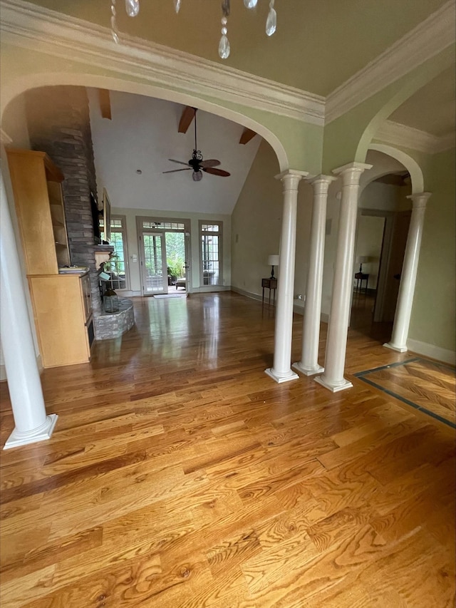 204 Tuscan Ridge Trl, Inman, SC 29349 - unfurnished living room featuring ceiling fan, light wood-style flooring, lofted ceiling, arched walkways, and crown molding