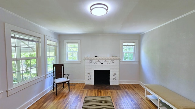 311 Hart St, Union, SC 29379 - living area featuring plenty of natural light, hardwood / wood-style flooring, ornamental molding, and a brick fireplace