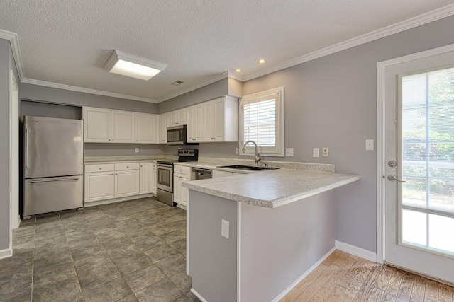 15 Arbours W Ln, Moore, SC 29369 - kitchen with stainless steel appliances, a peninsula, light countertops, white cabinetry, and crown molding
