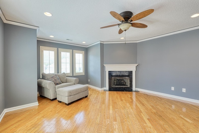 15 Arbours W Ln, Moore, SC 29369 - living room with light wood-style flooring, crown molding, ceiling fan, a textured ceiling, and a fireplace