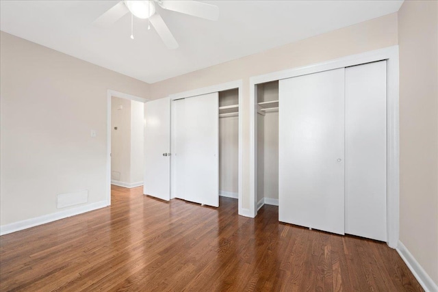 222 Woodview Ave, Spartanburg, SC 29306 - unfurnished bedroom with multiple closets, wood finished floors, and ceiling fan