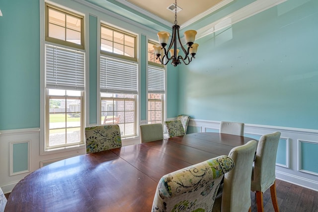 202 Buxton Ct, Easley, SC 29642 - dining room with a chandelier, a wainscoted wall, ornamental molding, dark wood-type flooring, and a decorative wall