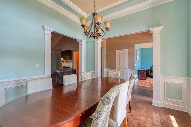 202 Buxton Ct, Easley, SC 29642 - dining space with ornate columns, a wainscoted wall, wood finished floors, crown molding, and a chandelier