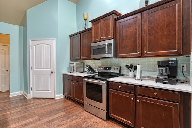 202 Buxton Ct, Easley, SC 29642 - kitchen featuring stainless steel appliances, light countertops, tasteful backsplash, dark brown cabinets, and dark wood finished floors