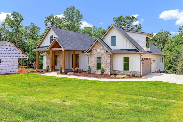 3963 Pennington Rd, Greer, SC 29651 - view of front of house with board and batten siding, driveway, a shingled roof, and a front lawn