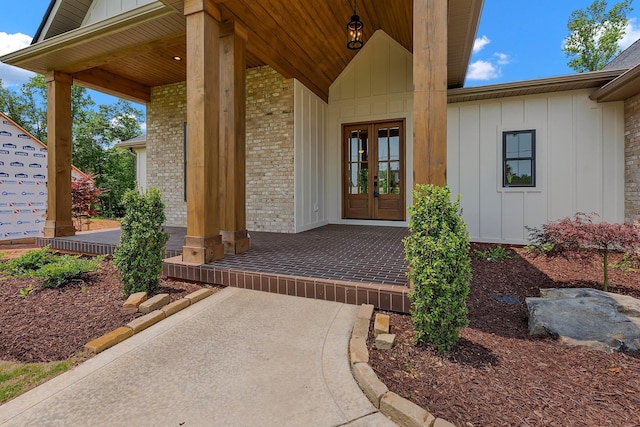 3963 Pennington Rd, Greer, SC 29651 - entrance to property featuring board and batten siding, french doors, brick siding, and covered porch