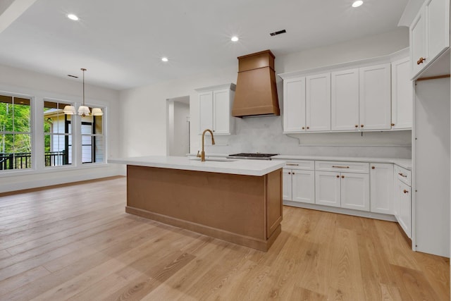 3963 Pennington Rd, Greer, SC 29651 - kitchen featuring premium range hood, light wood-style flooring, light countertops, white cabinets, and recessed lighting