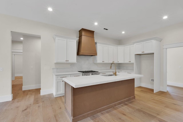 3963 Pennington Rd, Greer, SC 29651 - kitchen with custom exhaust hood, light countertops, white cabinetry, an island with sink, and recessed lighting