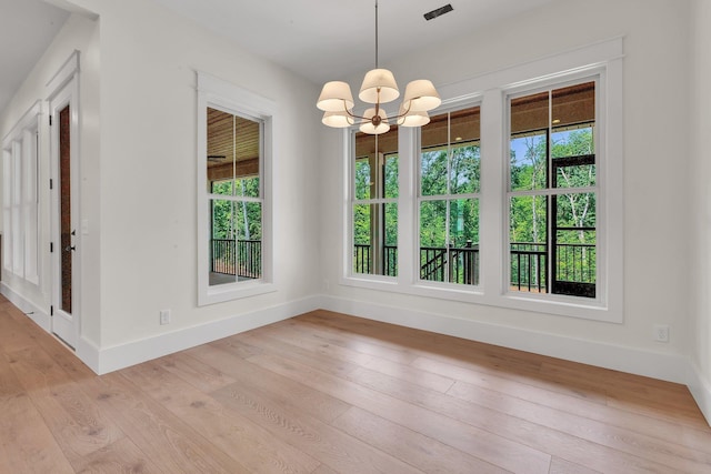 3963 Pennington Rd, Greer, SC 29651 - unfurnished dining area featuring healthy amount of natural light, a chandelier, and light wood-type flooring