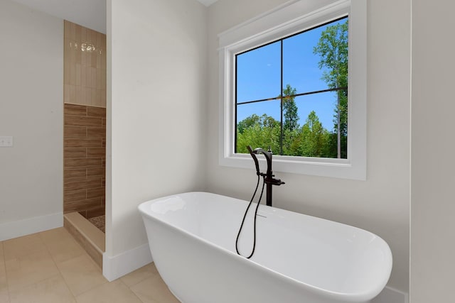 3963 Pennington Rd, Greer, SC 29651 - bathroom featuring healthy amount of natural light, a soaking tub, tile patterned flooring, and a tile shower