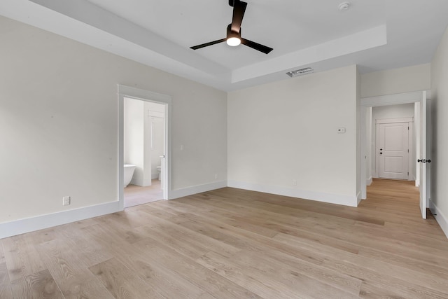3963 Pennington Rd, Greer, SC 29651 - empty room featuring ceiling fan, a tray ceiling, light wood-style floors, and a smoke detector