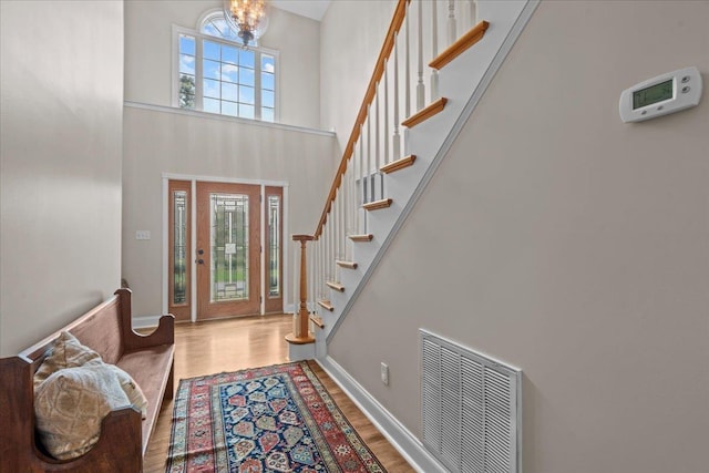 155 Lake Park Dr, Spartanburg, SC 29301 - foyer entrance featuring a high ceiling, stairway, wood finished floors, and a chandelier