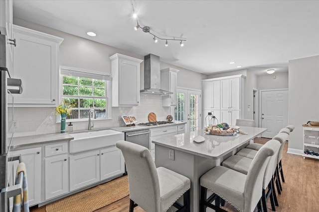 155 Lake Park Dr, Spartanburg, SC 29301 - kitchen with wall chimney range hood, a kitchen breakfast bar, white cabinets, plenty of natural light, and recessed lighting