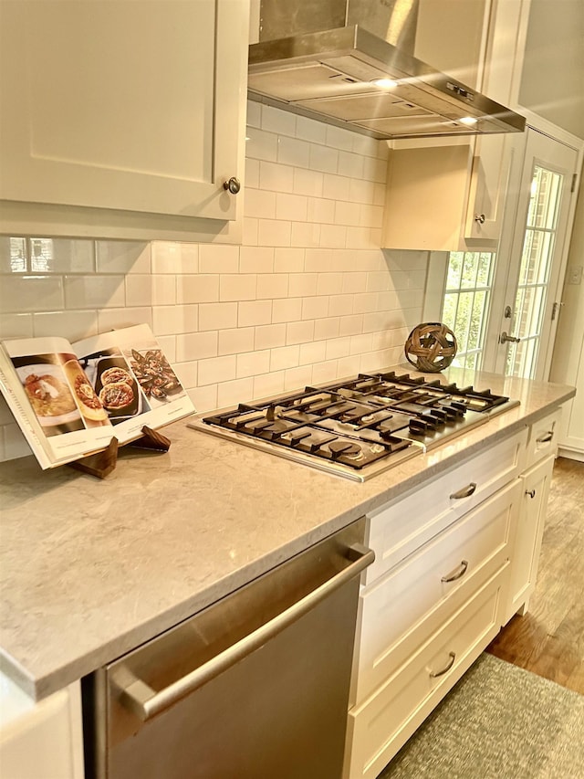 155 Lake Park Dr, Spartanburg, SC 29301 - kitchen with ventilation hood, stainless steel appliances, white cabinetry, decorative backsplash, and light stone counters