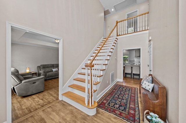 155 Lake Park Dr, Spartanburg, SC 29301 - stairs with wood finished floors, a towering ceiling, and attic access
