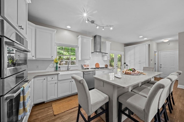 155 Lake Park Dr, Spartanburg, SC 29301 - kitchen with wall chimney range hood, appliances with stainless steel finishes, a kitchen breakfast bar, healthy amount of natural light, and recessed lighting