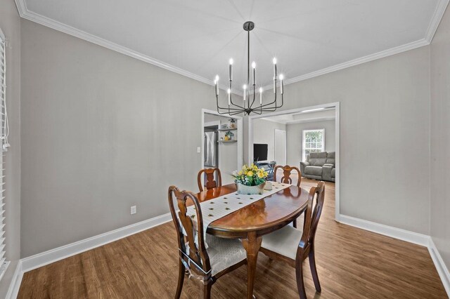 155 Lake Park Dr, Spartanburg, SC 29301 - dining area featuring a chandelier, wood finished floors, and ornamental molding
