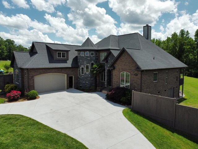 473 Meadow Rd, Inman, SC 29349 - french country style house featuring concrete driveway, brick siding, a chimney, and a garage