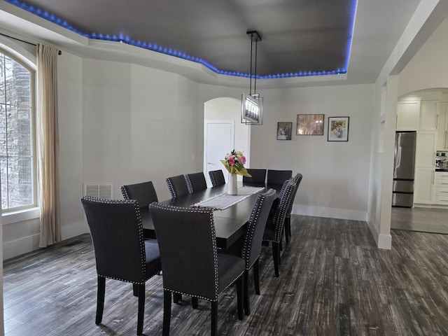 473 Meadow Rd, Inman, SC 29349 - dining space with a raised ceiling, arched walkways, dark wood-type flooring, and plenty of natural light